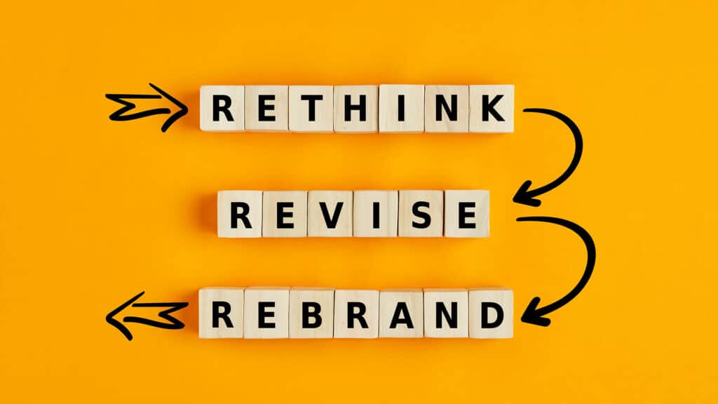 Text that says "Rethink, Revise, Rebrand" on an orange background